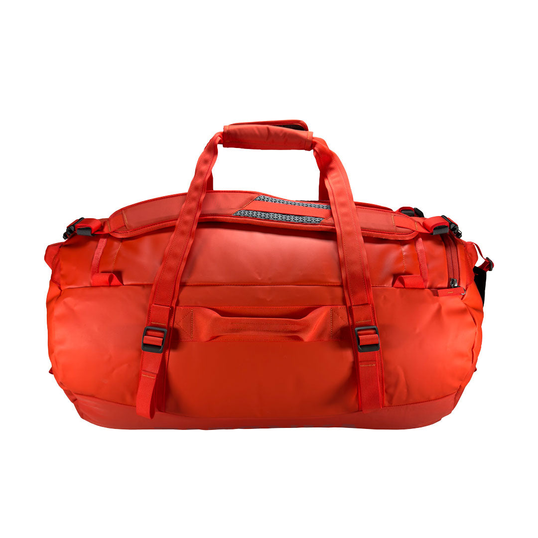 Back view of 65 litre Tatonka barrel bag with adjustable, top carry handles, grab handles on all sides, and padded, removable and adjustable backpack shoulder straps. Main body has compression straps and a padded bottom - Red