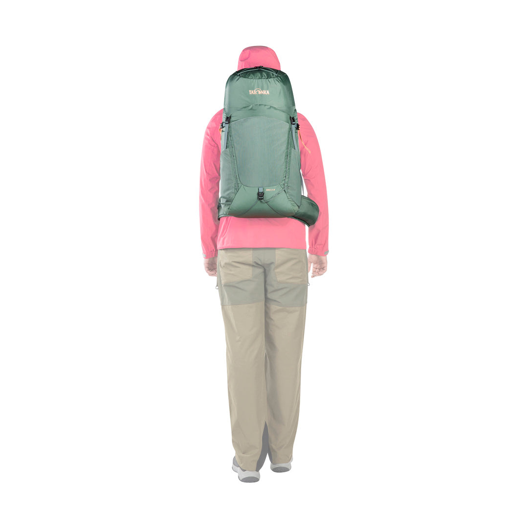 Back view of woman wearing the 31 litre Tatonka Norix women's pack with detachable padded hip belt in place