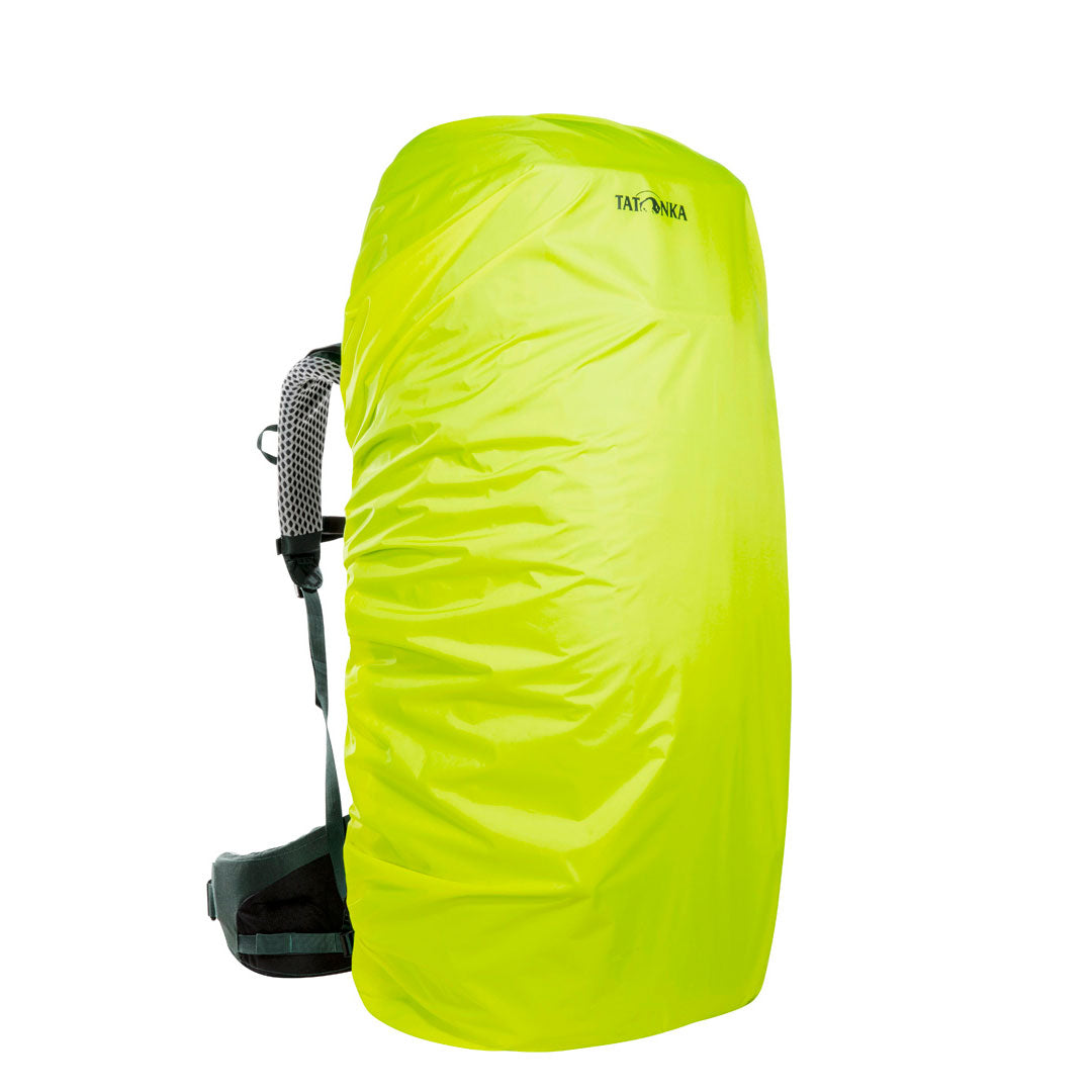 Front three quarter view of 70/10 litre Tatonka branded Yukon pack with included  fluro yellow rain guard in place