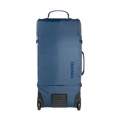 Front view of 140 litre Tatonka Duffel Roller with grab handle on top, compression straps at side and wheels on facing bottom edge - Navy