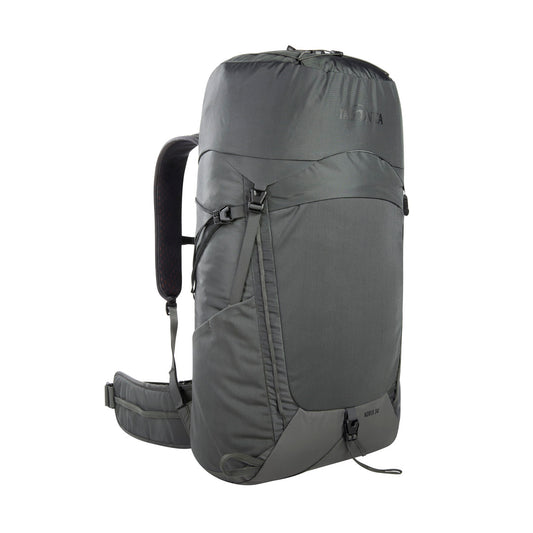 Front three quarter view of 34 litre Tatonka Norix pack with snow guard, fixation for hiking poles, load control strips and side compression straps, top handle, lid compartment with key holder and elastic zigzag lacing. Also features side elastic pockets, gear loops and elastic pocket on front, with fixation straps at the bottom – Titan Grey | Ships Within NZ