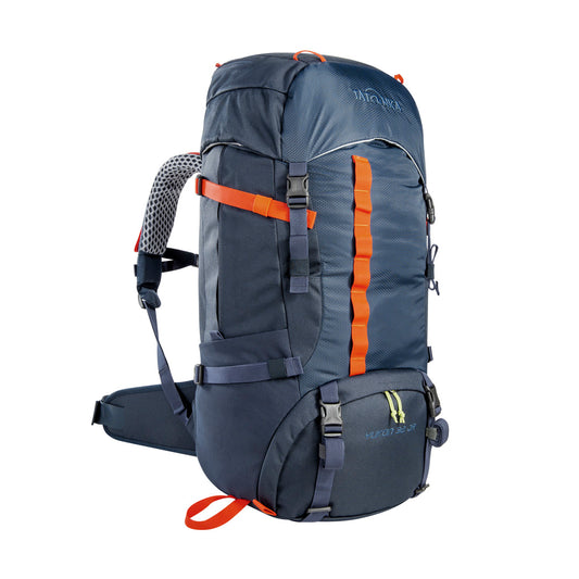 Front three quarter view of 32 litre Tatonka branded Yukon 32 JR pack with load control straps, side compression straps, compression around perimeter of base, zipped side pockets with expansion pleats and standard side pockets. Also features Gear loops on lid, front daisy chain, and hiking pole fixation points – Navy with Orange highlights | Ships Within New Zealand