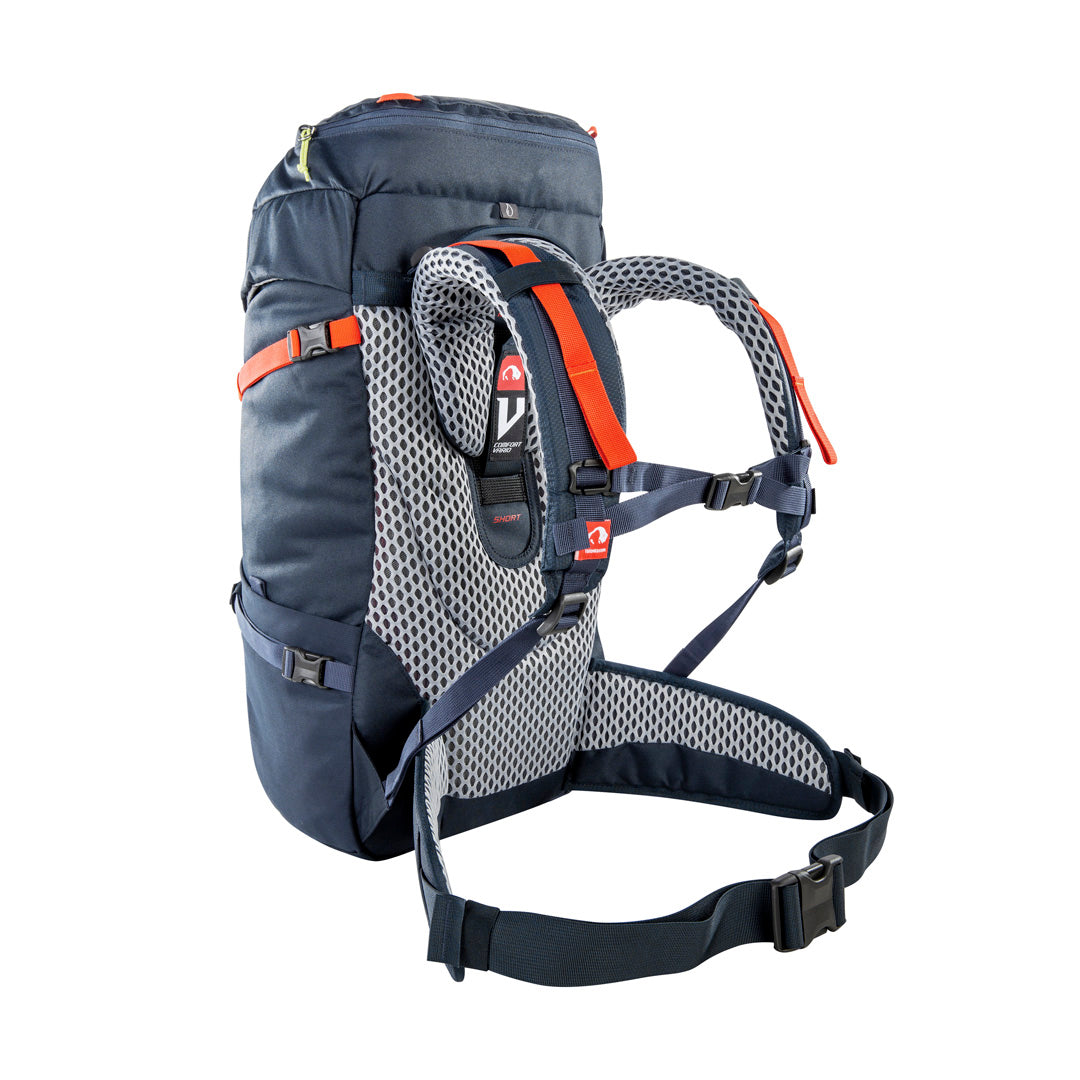 Back three-quarter view of 32 litre Tatonka branded Yukon 32 JR pack with V Comfort Vario carrying system including length-adjustable for body sizes from age 8 through to smaller adults, padded hip belt for proper weight transfer, carrying handle, single-handed hip belt adjustment through redirected fixation design and height-adjustable chest strap – Navy with Orange highlights